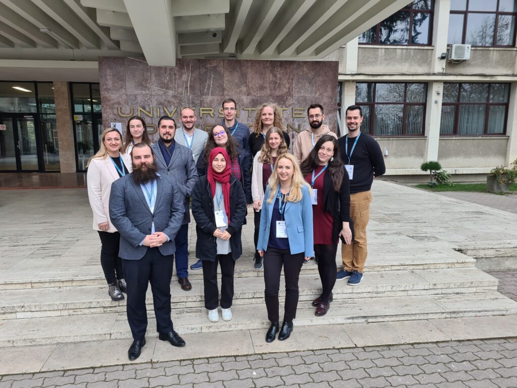 Multiple members of the student expert pool in front of a university building